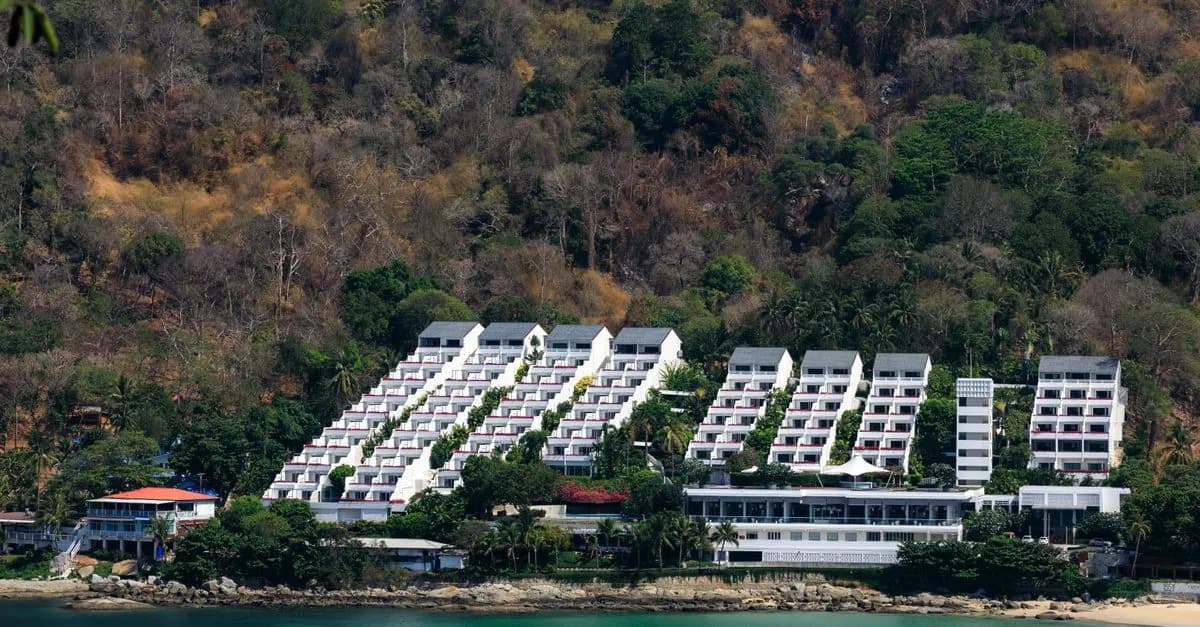 A scenic view of a modern resort nestled on the lush coastline of Phuket, Thailand.