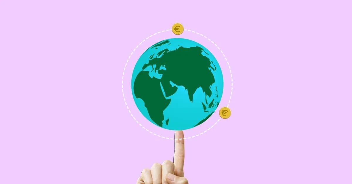 Hand balancing Earth with Euro symbols, illustrating global economy.
