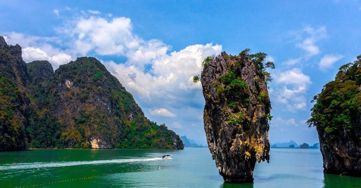 Stunning rock formations at James Bond Island, Thailand with vibrant green waters and blue skies.