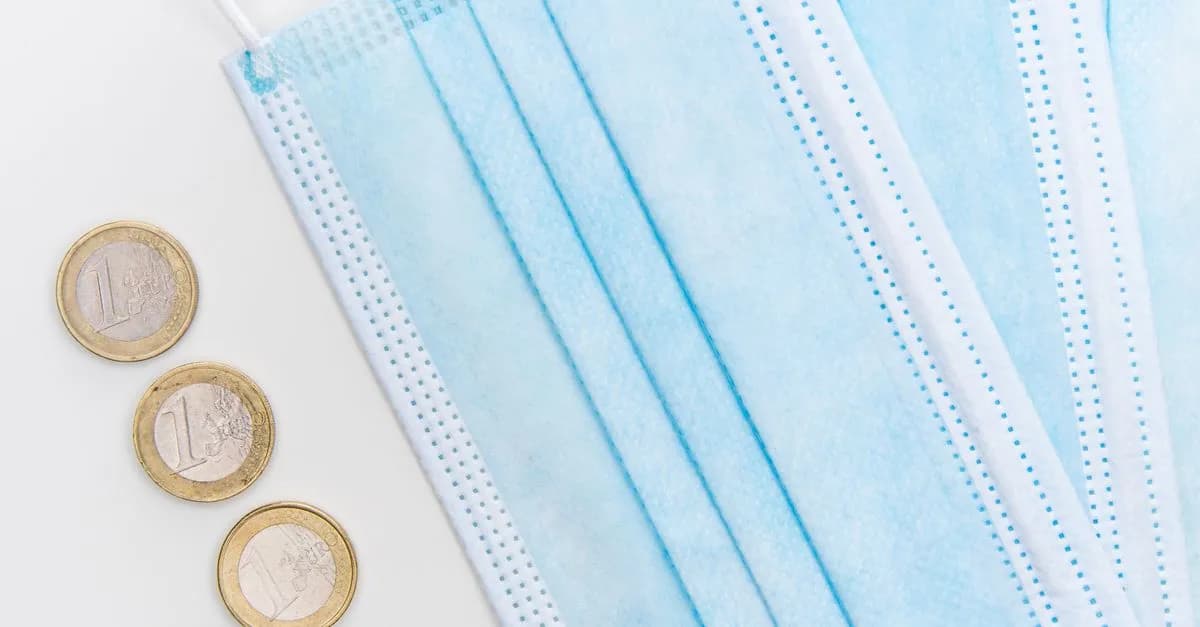 Flatlay of surgical face masks and euro coins, symbolizing pandemic economic challenges.